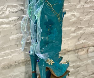 Élysée Papillon — Iridescent ribbon bows cascade down the backs above dangling blue heart-shaped charms.
